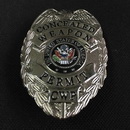 silver metal CWP badge